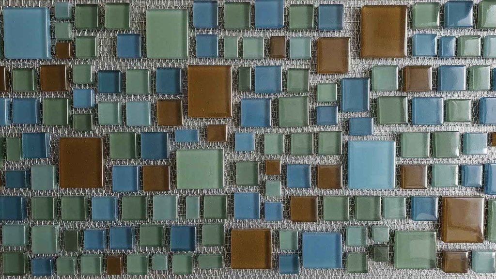 A Mosaic Glass Backsplash with Metallic Mesh
